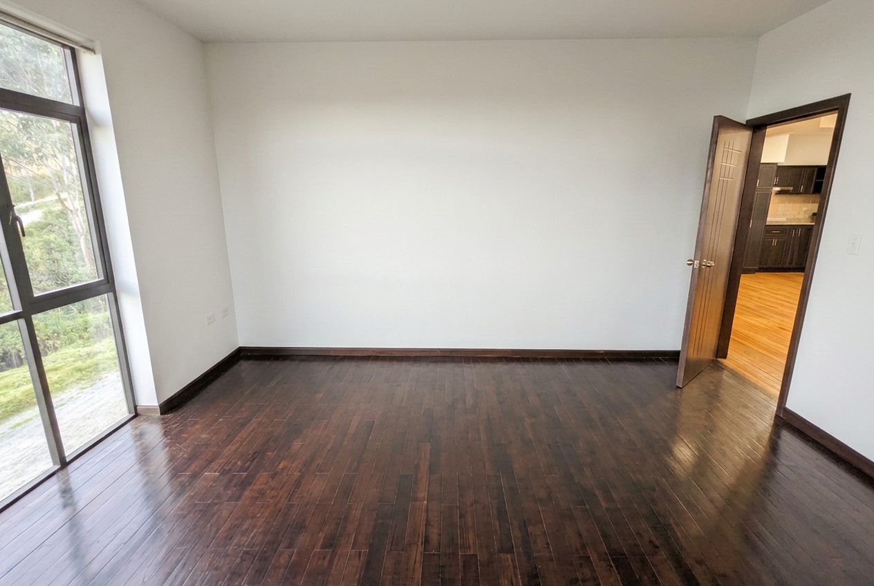 Empty primary bedroom, before staging